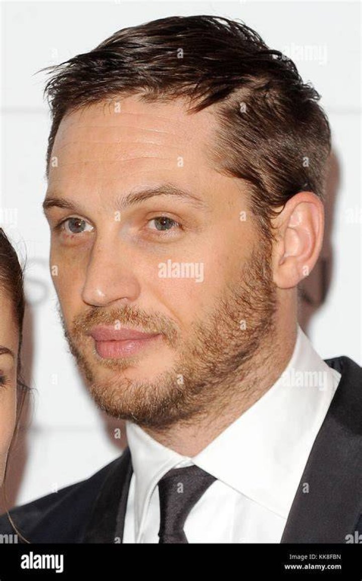 English actor Tom Hardy and his girlfriend Charlotte Riley attend the